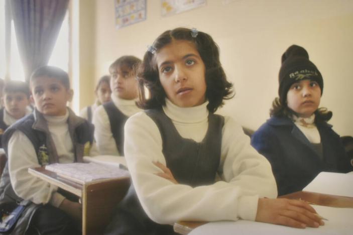 Fourth-grade students react to their teacher explaining that they may be killed by warplanes, should the U.S. invade