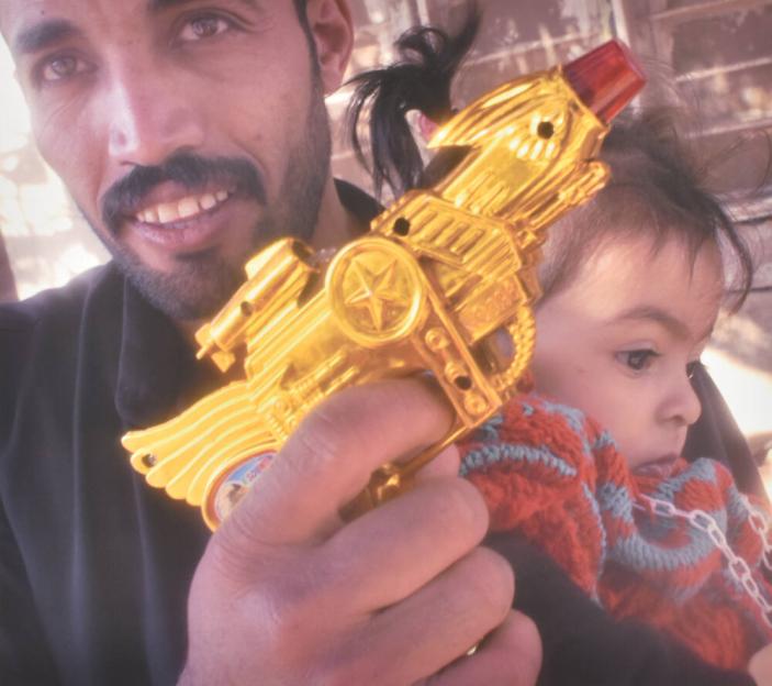 Father with ray gun and daughter, village of Falah Hamud as Salim