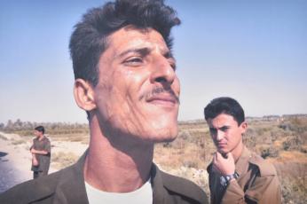 An Iraqi policeman, who says he was tortured by Hussein's forces, stops traffic after an attack against U.S. soldiers, Ar 
Ramadi