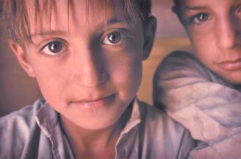 Boys at a feast commemmorating 2,900 Shia Muslims buried in a mass grave after a 1991 uprising against Hussein