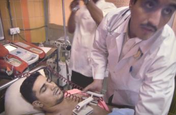 Physicians at Medicine City Hospital administer shocks to gunshot victim Ammar Shakar, dead at age 26, Baghdad