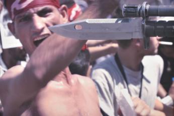 Members of the Iraqi Workers' Union face off against bayoneted U.S. soldiers during a protest against unemployment
