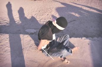 Boy captured with a hand grenade, AK-47 and banana clips by U.S. Army troops, Ar Ramadi