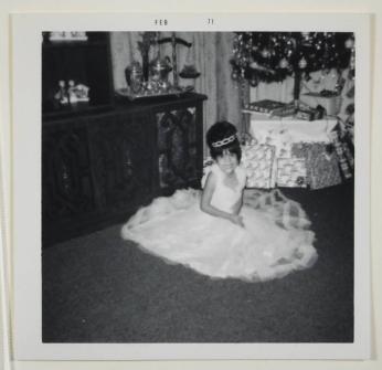 [Girl in Dress Posing in Front of Christmas Tree and Wrapped Presents]