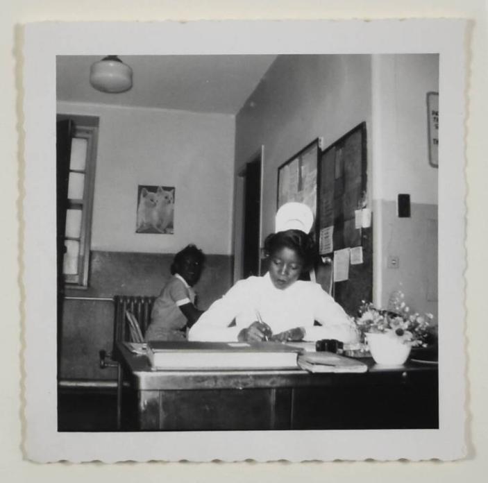 [Nurse Seated and Writing]