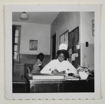[Nurse Seated and Writing]