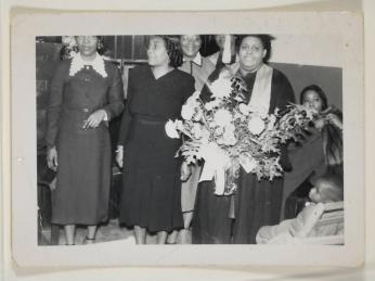 [Woman on Graduation Day with Cap and Gown, Holding Bouquet]