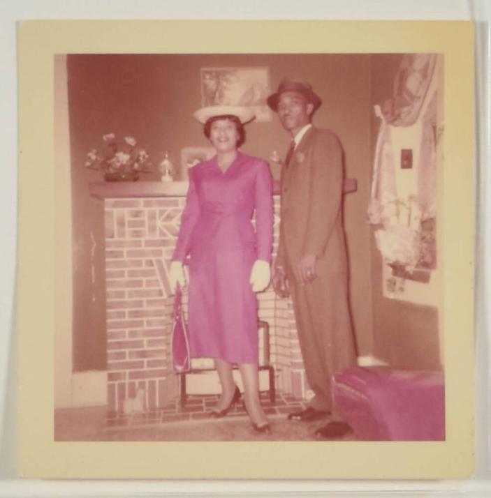 [Woman in Dress and Man in Suit, Posed in Front of Fireplace]