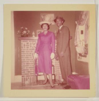 [Woman in Dress and Man in Suit, Posed in Front of Fireplace]