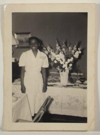 [Woman Smiling in Front of Table Set with Food and Flowers]