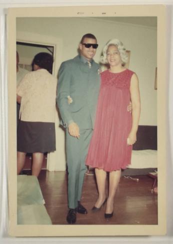 [Man in Sunglasses and Woman with Red Dress Posing at Party]