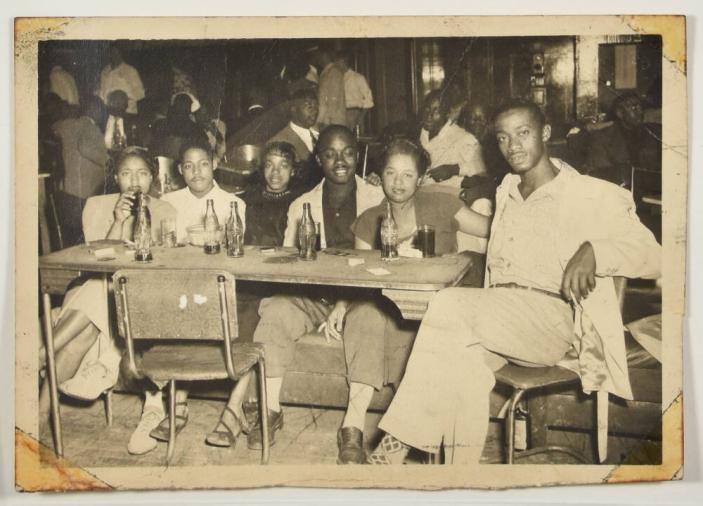 [Group of Women and Men Seated at a Table at a Club]