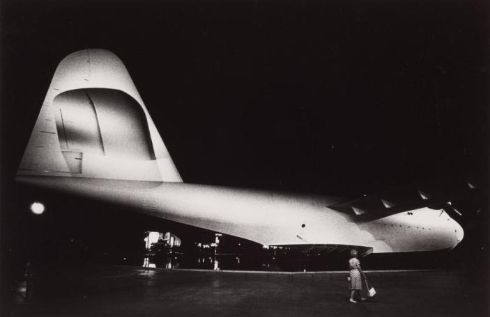 [Howard Hughes’ Spruce Goose Airplane, Woman with Purse]