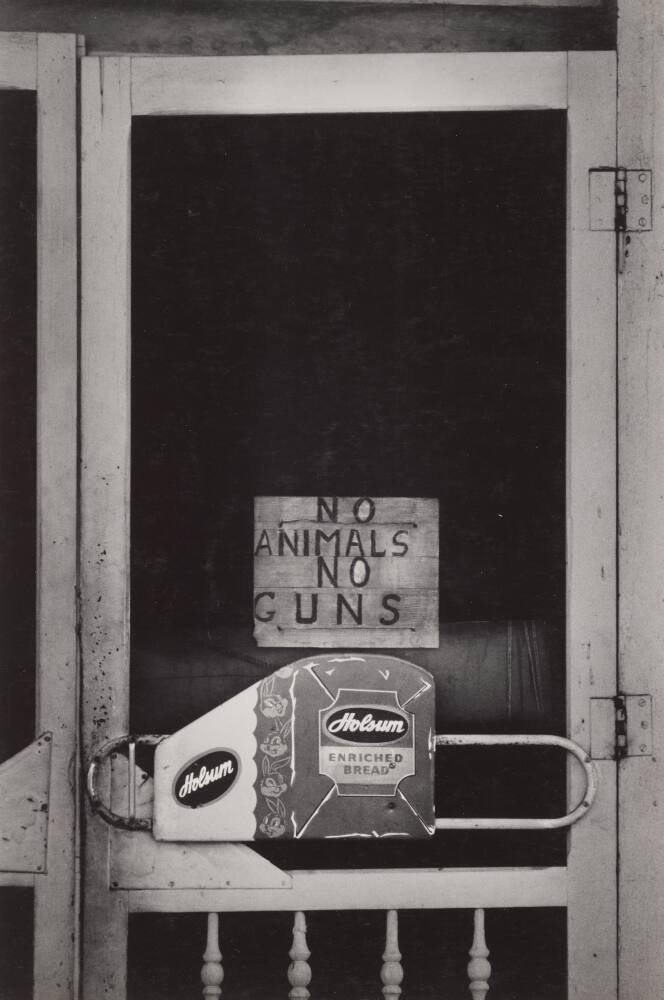 [Screen Door With Sign “No Animals No Guns” and Holsum Enriched Bread]