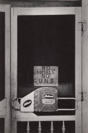 [Screen Door With Sign “No Animals No Guns” and Holsum Enriched Bread]