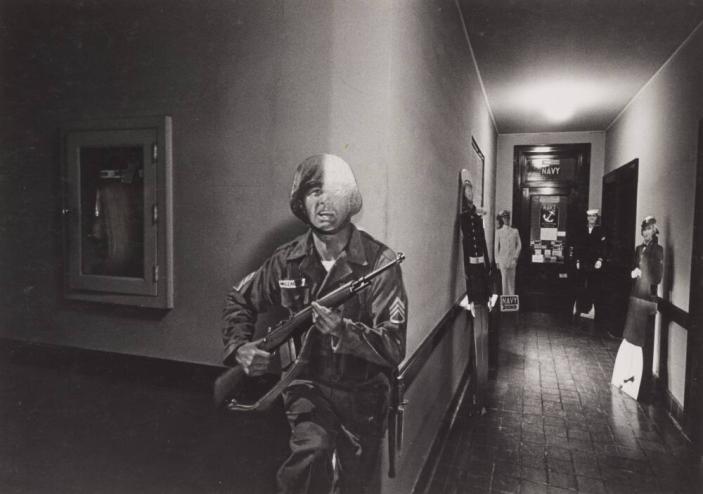 [Cut-Out of Military Personnel in Hallway to Navy Recruitment Office]