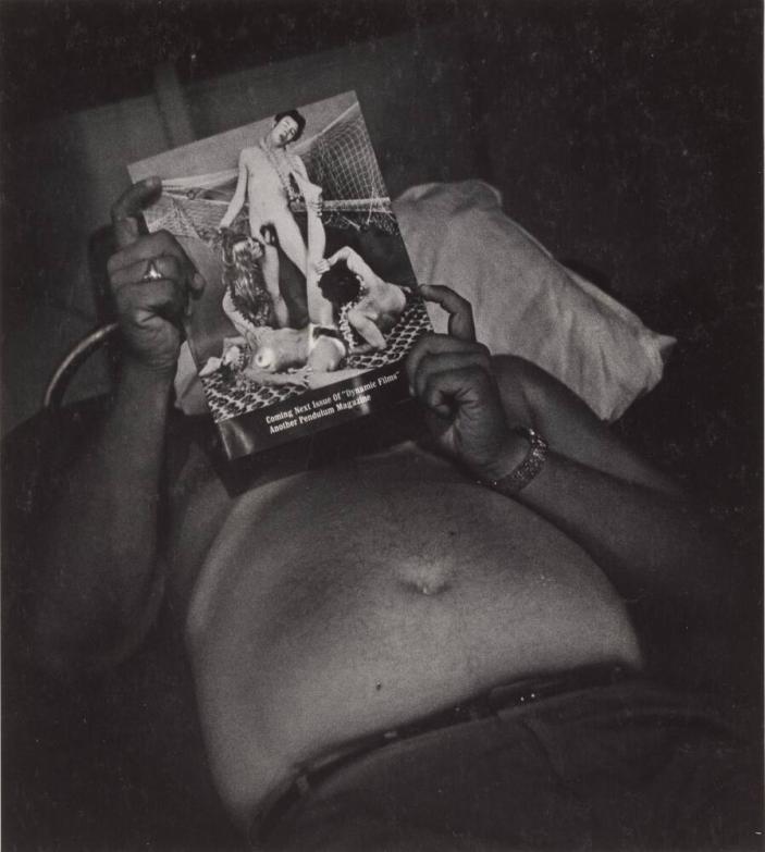 [Shirtless Man Reclining Looking At Pornographic Magazine]