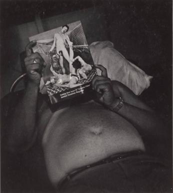 [Shirtless Man Reclining Looking At Pornographic Magazine]