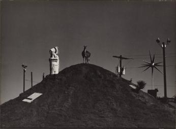 [Small Hilltop With Power Poles, Indian Chief Statue, Llama, Power Poles]