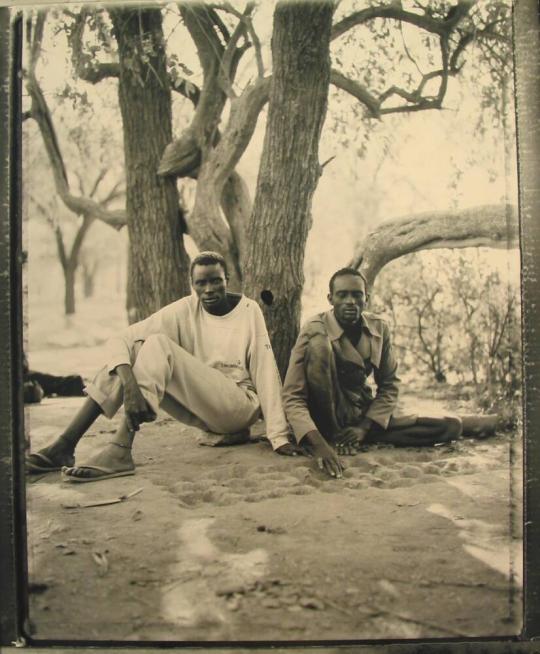 Mariam Mac and Agot Anyang Playing 'Bao', Family Section, Sudanese Refugee Camp, Kahuma, Kenya