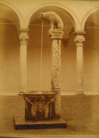 Fountain in court - Lion atop column, water drops into basin - Arched walkway in background