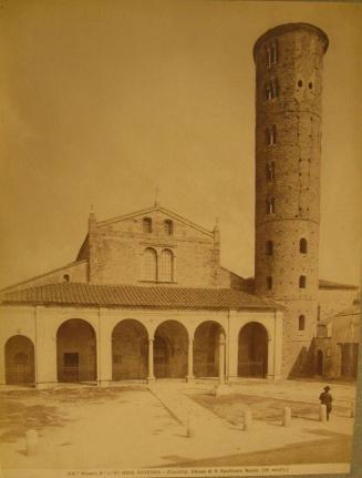 Church:   Arched facade,  Circular tower on image right.