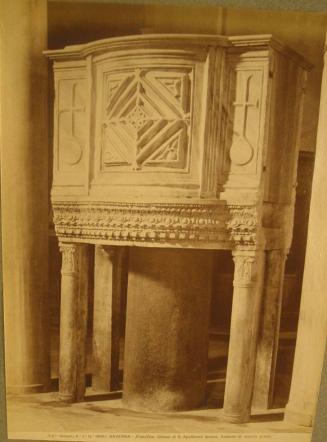 Raised pulpit.  Heavy plain central column with four smaller decorative corner support columns.  Concentric diamonds in center