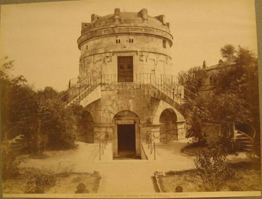 Circular mausoleum.  Step down to lower entrance.  Two sets of stairs up to second level entrance.