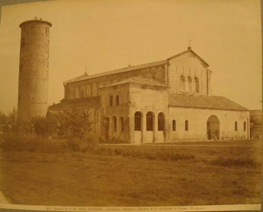 View of basilica in field, circular  tower to left of image