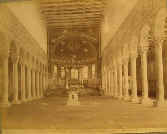 Basilica interior, facing towards altar. Dome over altar has cross, figure surrounded by sheep