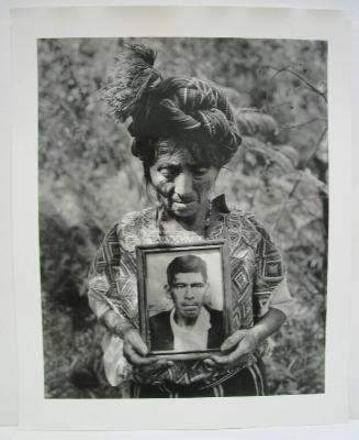 During an Exhumation, Doña Clara Holds a Photograph of Her Husband Whose Remains Were Being Unearthed