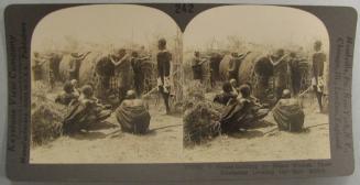 House Building by Masai Women, Their Husbands Looking On-East Africa