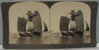 Picturesque Chinese Junk under Full Sail on the Yellow Sea, Coast of Manchuria in Distance.