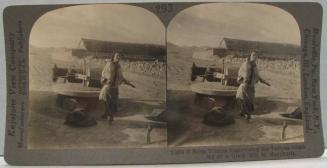 Farm Woman Supervising the Tedious Grinding of a Grain Mill in Manchuria.