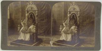 Pope Pius X, bestowing his benedicition as Supreme Pontiff, from his throne in the Vatican, Rome.