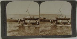 Fishermen on the Sea of Galilee and distant hills of the Gadarenes, Palestine.