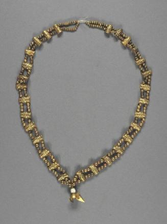 Necklace with beads in the form of human heads