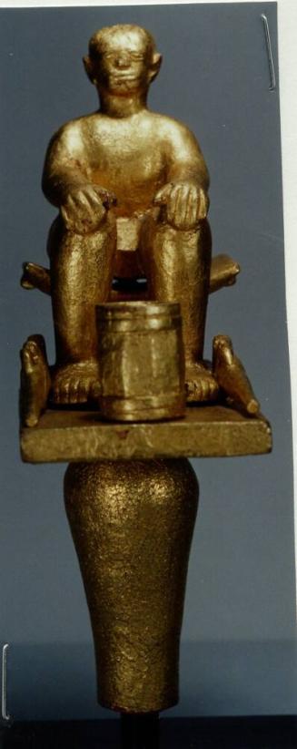 Linguist Staff Finial Representing a Seated Man with Rifles and a Powder Keg