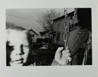 Untitled (Child on Swing Set Holding Chain)