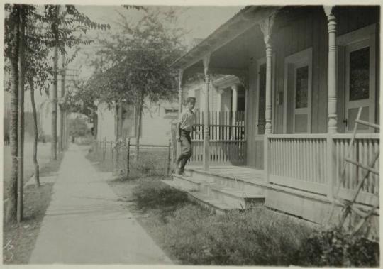 Sixteen year old messenger boy entering “crib” in Red Light District. San Antonio, Texas.